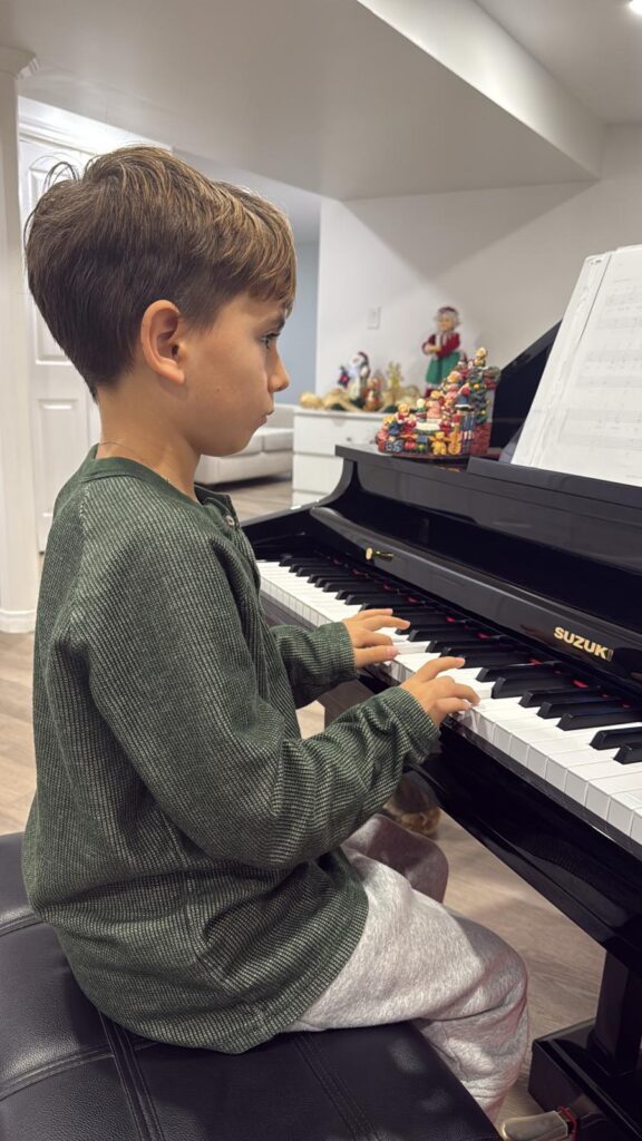 Young student practicing piano during a music lesson at Nova Music Academy in London, Ontario